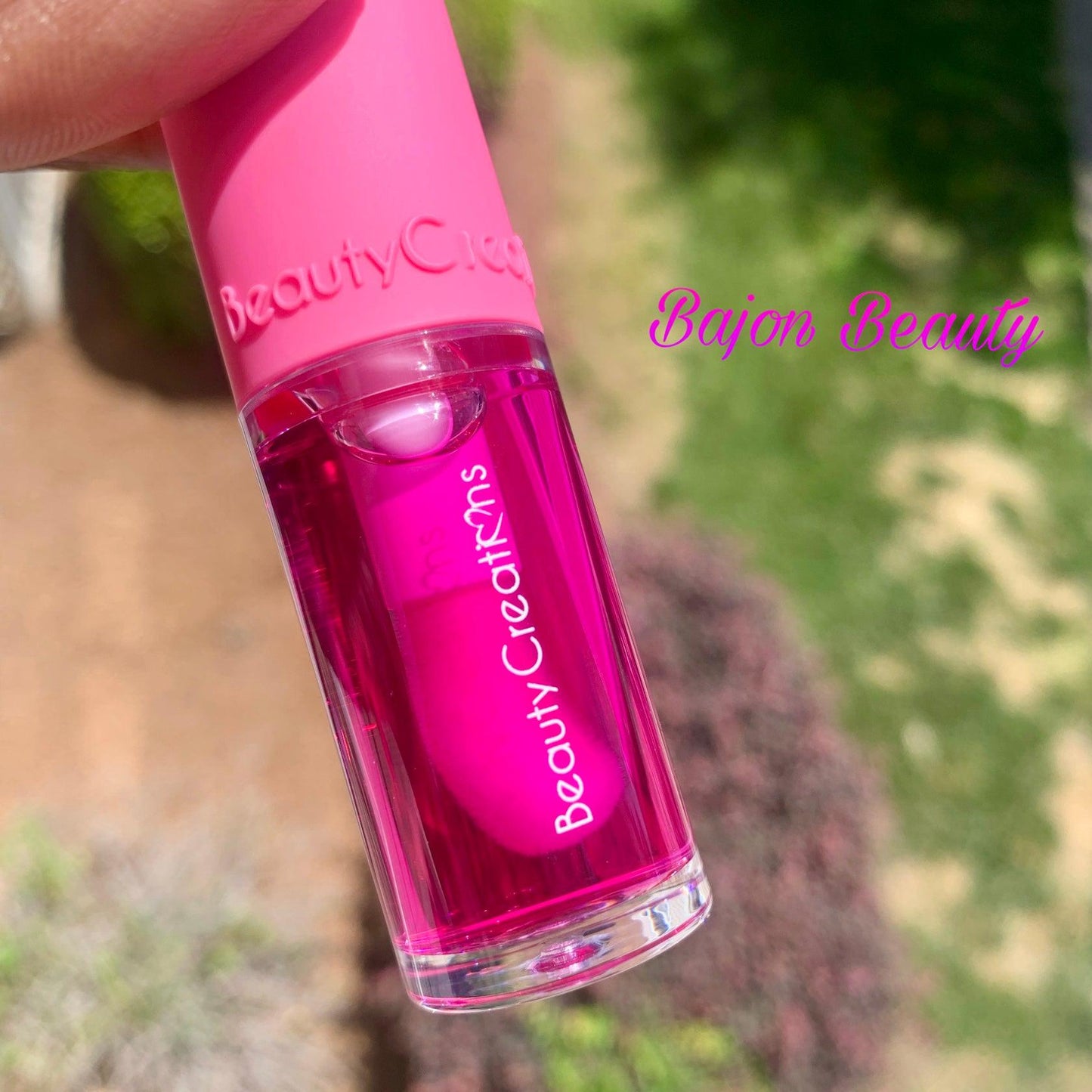 Hydrating lip oil with a pink tint.