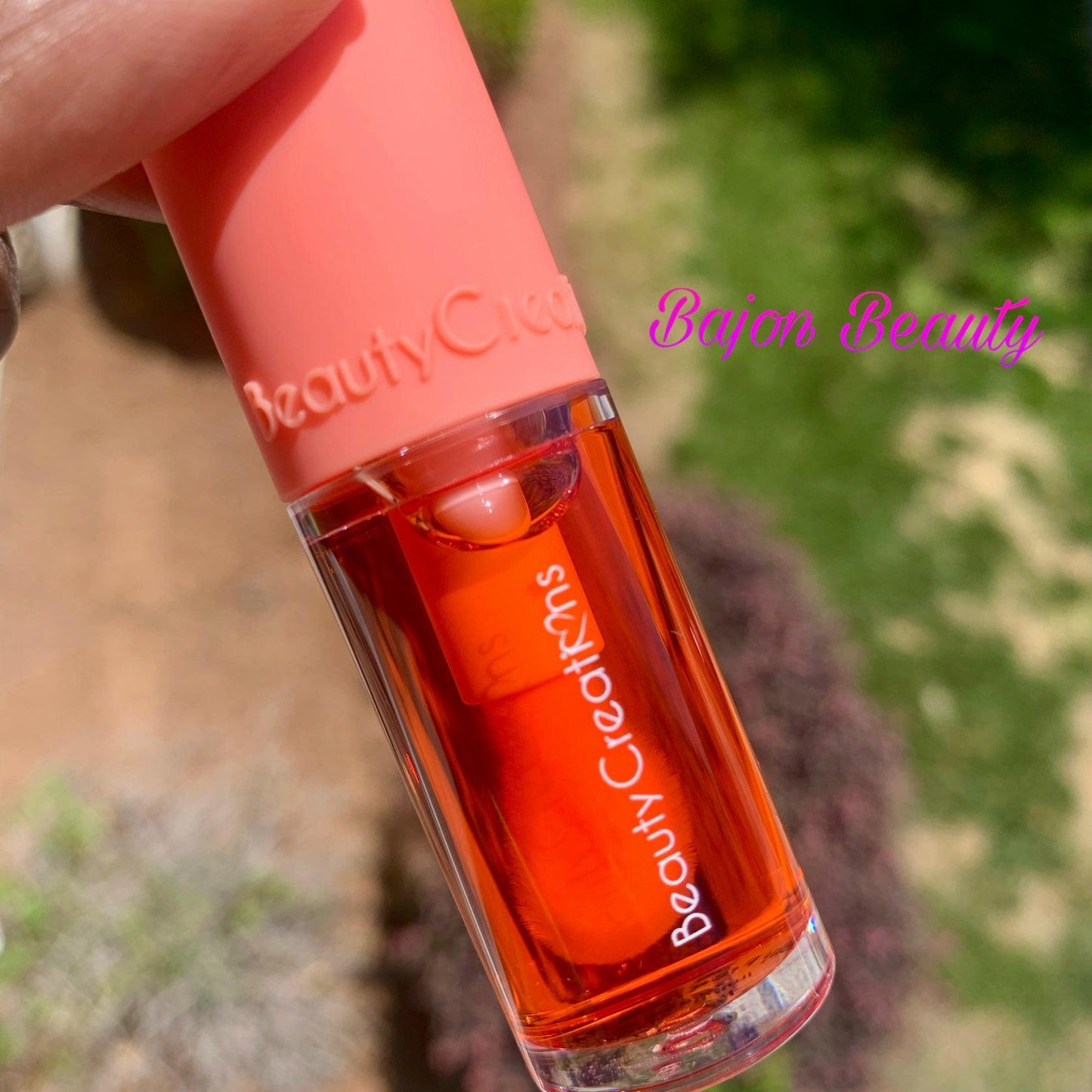 Hydrating lip oil with a lip orange tint.