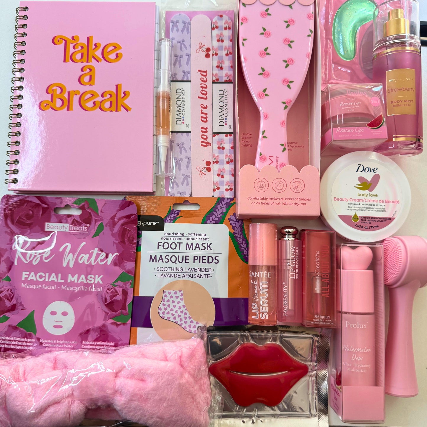 Collection of beauty and self-care products including a notebook, facial mask, and hairbrush.