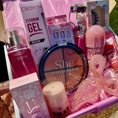 Unboxing pink beauty kit with tissue paper revealing lip care, makeup, and lashes inside gift box